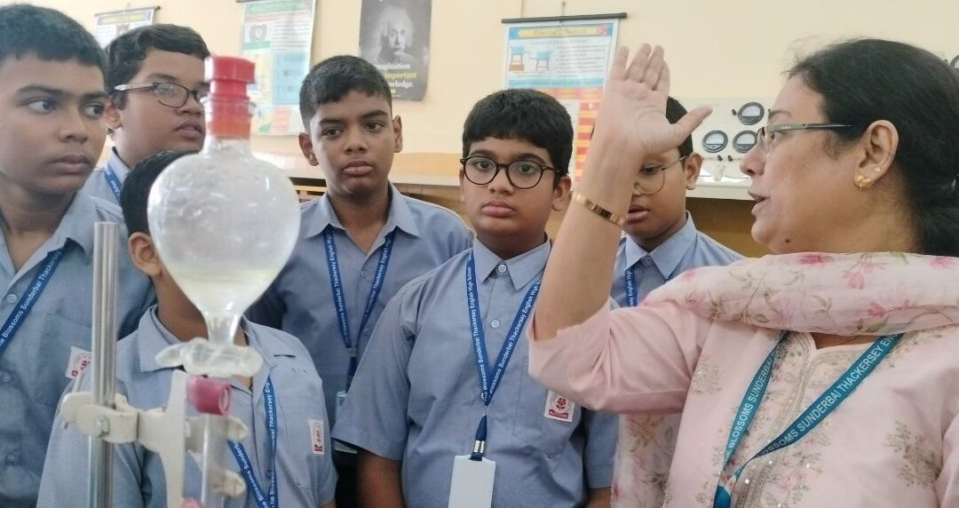 Students of std 8A observing the separating technique of separating immiscible liquids using a separating funnel. The teacher also demonstrated the use of a centrifuge machine to separate particles suspended in a liquid.The students were also given an opportunity to handle the apparatus